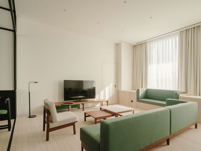 Architectural glass walls used for privacy in a modern hotel suite.