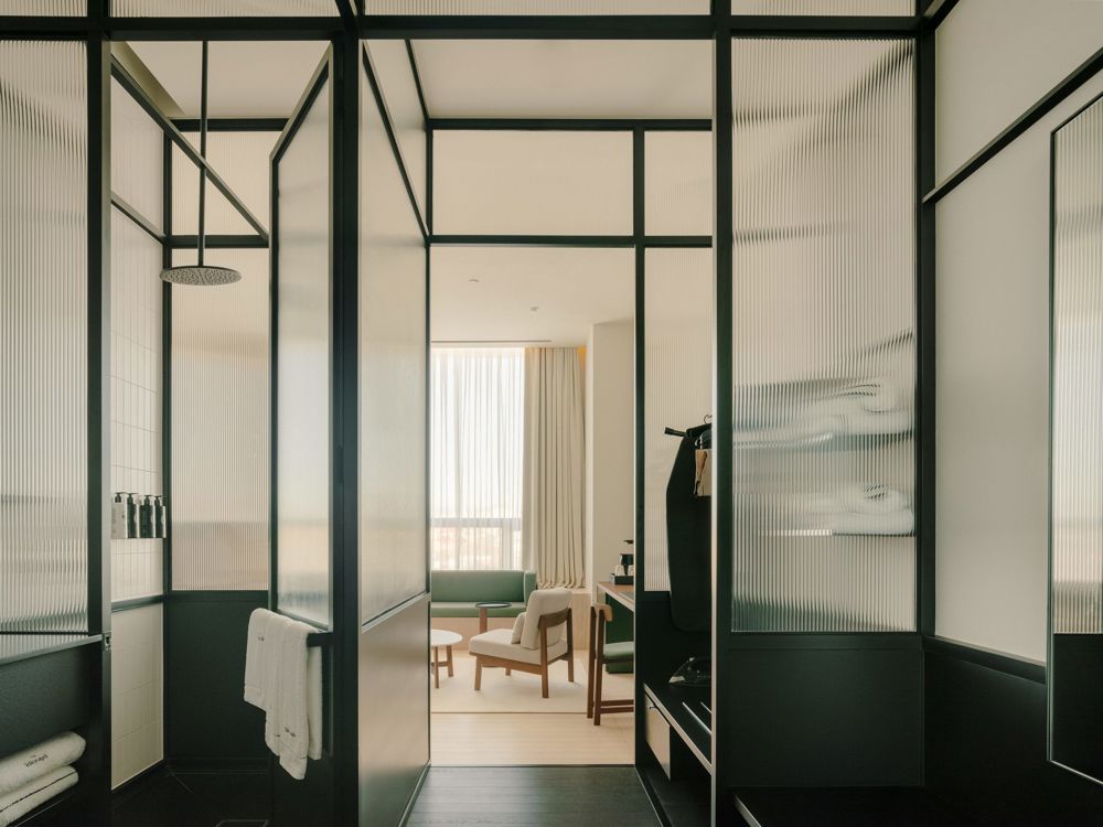 Smart TV and entertainment unit integrated into a Deluxe Room wall.