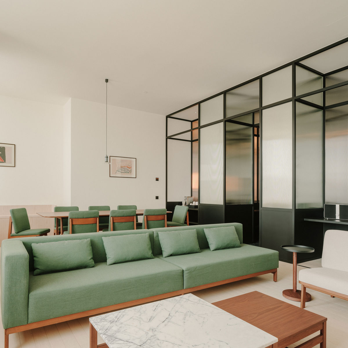 Luxury separate living area featuring a mid-century modern sofa and velvet textures.