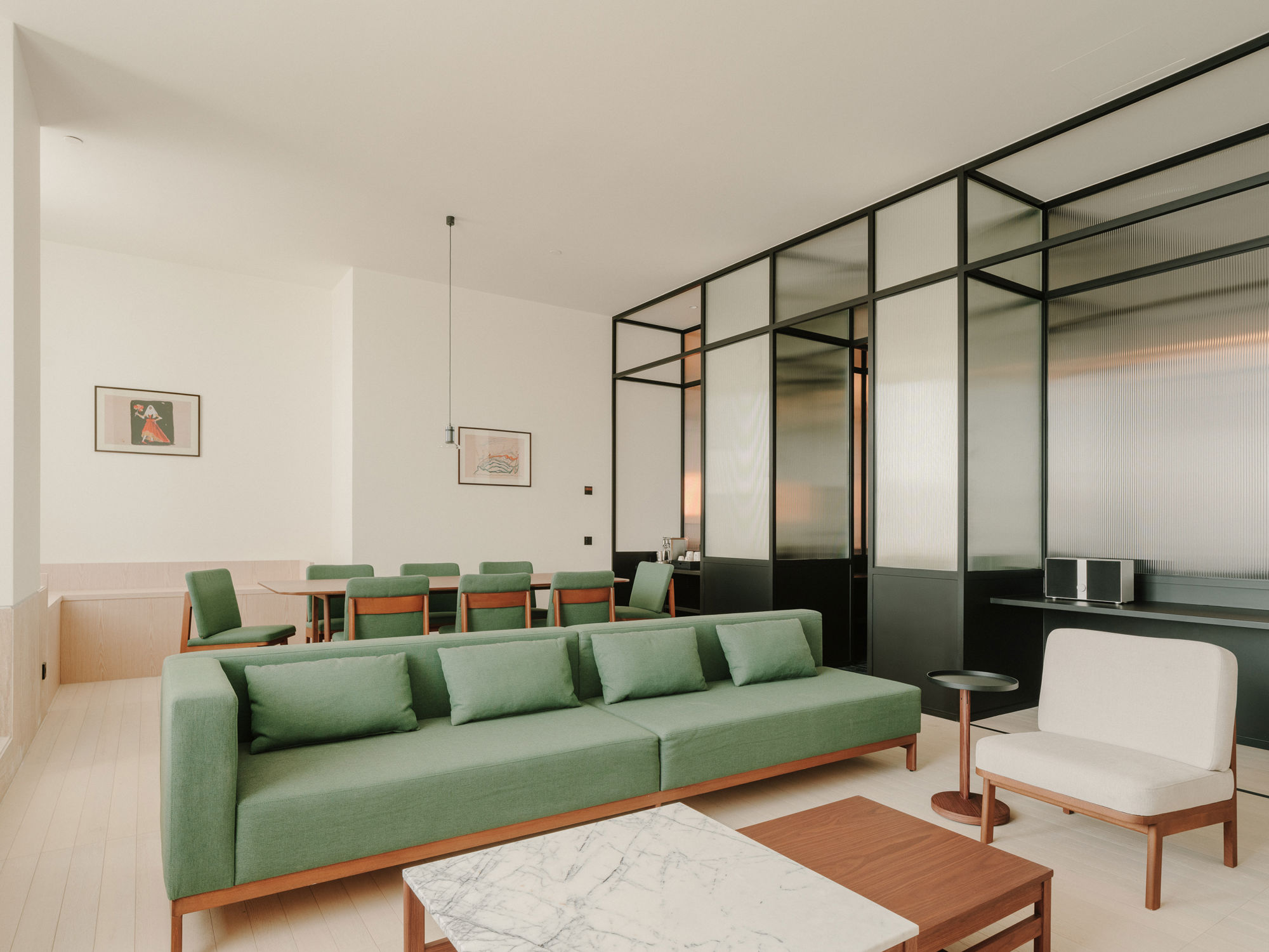 Luxury separate living area featuring a mid-century modern sofa and velvet textures.