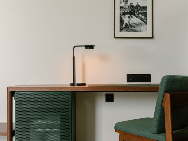 Natural light filling a Deluxe Room through large historic windows at The Telegraph Hotel.