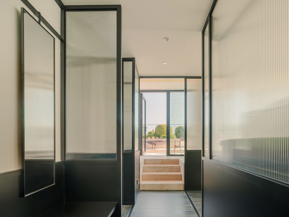 Luxury suite terrace with outdoor lounge seating and city skyline views.